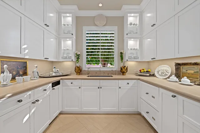 a kitchen with white cabinets and white appliances