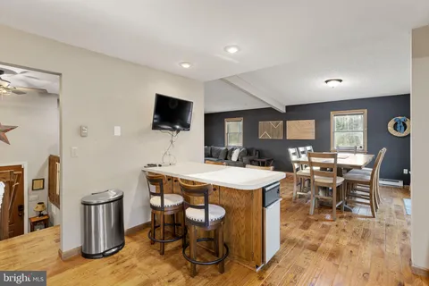 a bathroom with a granite countertop sink and a toilet