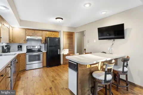 a bedroom with a bed and painting on the wall