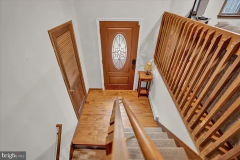 a bedroom with a bed and painting on the wall