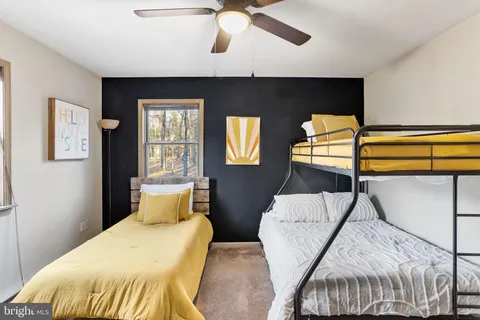 a bed sitting in a bedroom next to a window