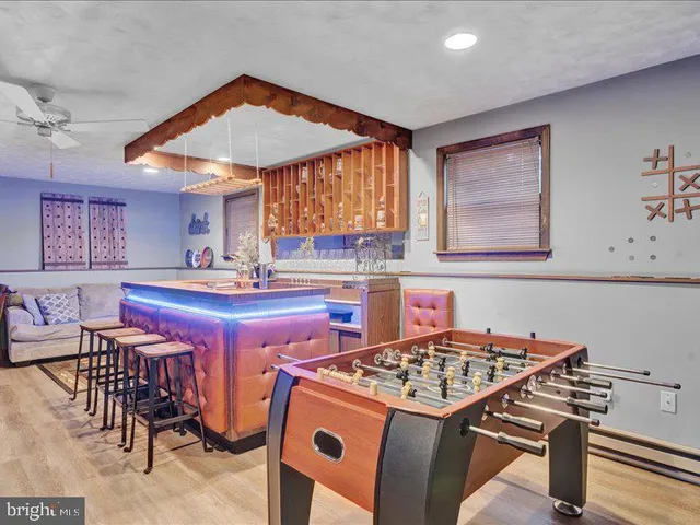 a living room with lots of furniture and a wooden floor