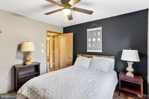 a bed sitting in a bedroom next to a window