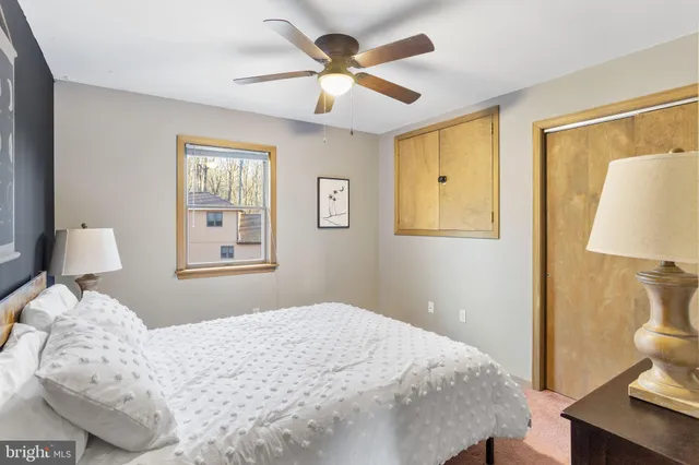 a view of a hallway with wooden floor and closet area