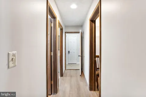 an aerial view of residential houses with outdoor space and trees