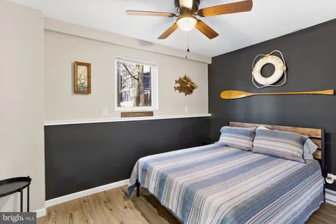 an aerial view of residential house with outdoor space and trees all around