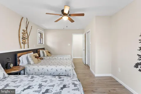 an aerial view of residential houses with outdoor space and trees