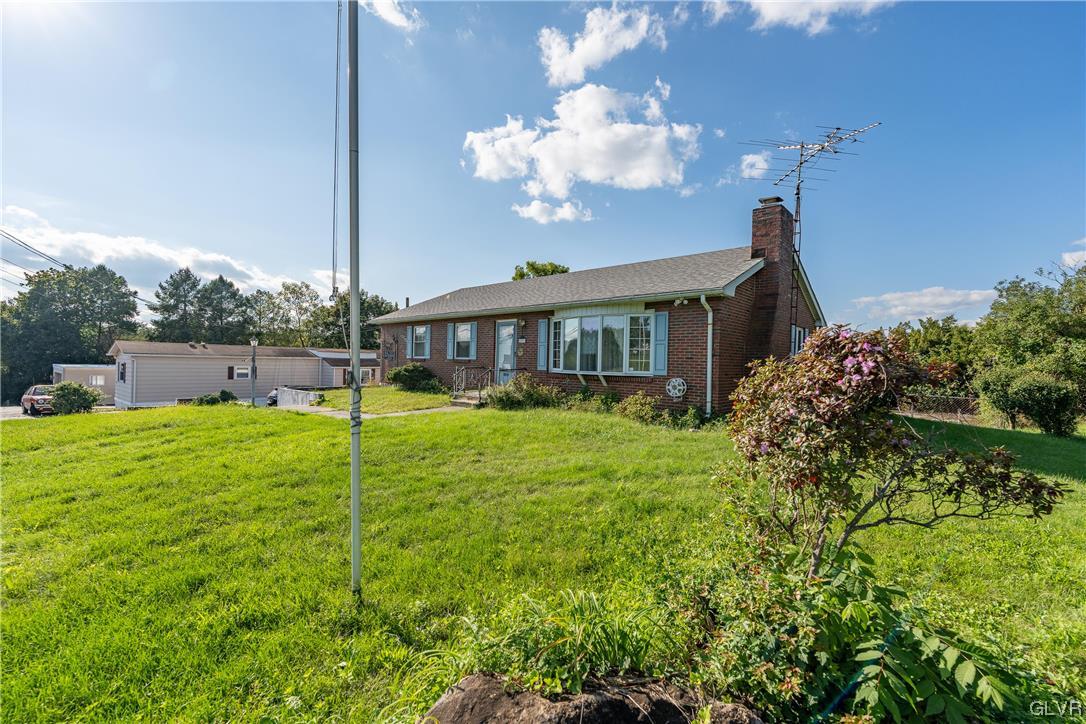 6991 Hilltop Road Allentown, PA 18106 - Photo 18 of 26 a view of a house with a big yard and potted plants