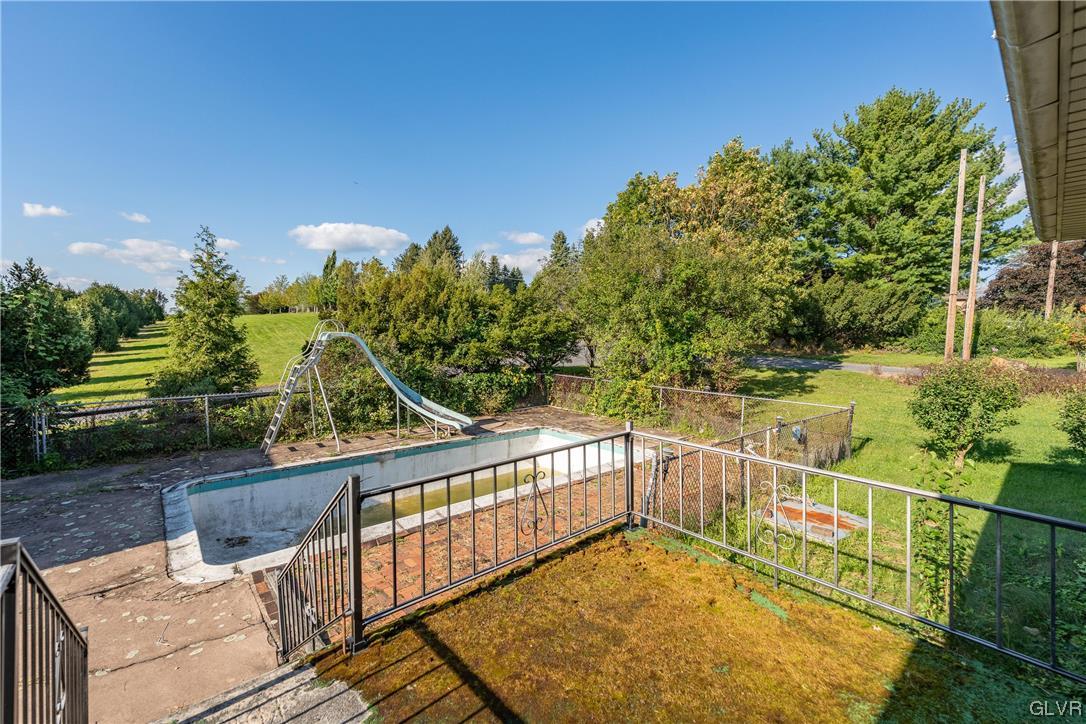 6991 Hilltop Road Allentown, PA 18106 - Photo 22 of 26 a view of a balcony with floor to ceiling window and wooden fence