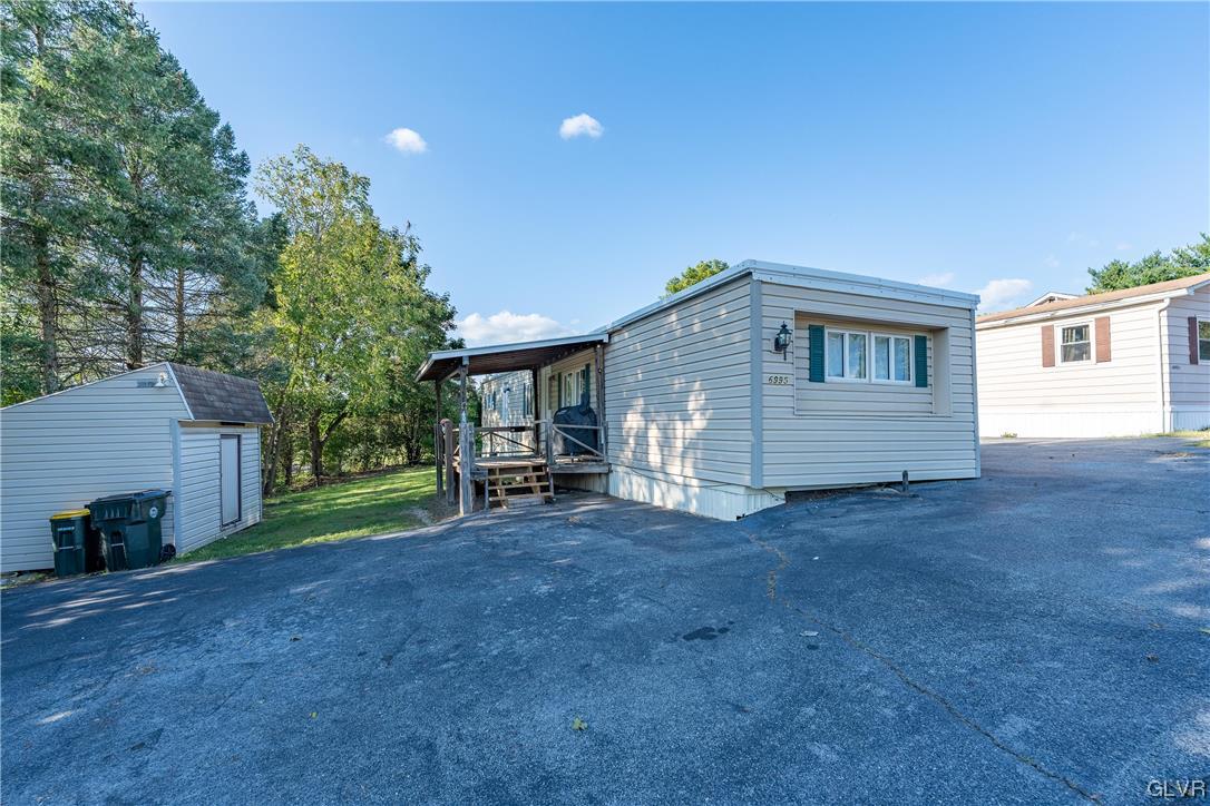 6991 Hilltop Road Allentown, PA 18106 - Photo 23 of 26 a view of a house with backyard and a tree