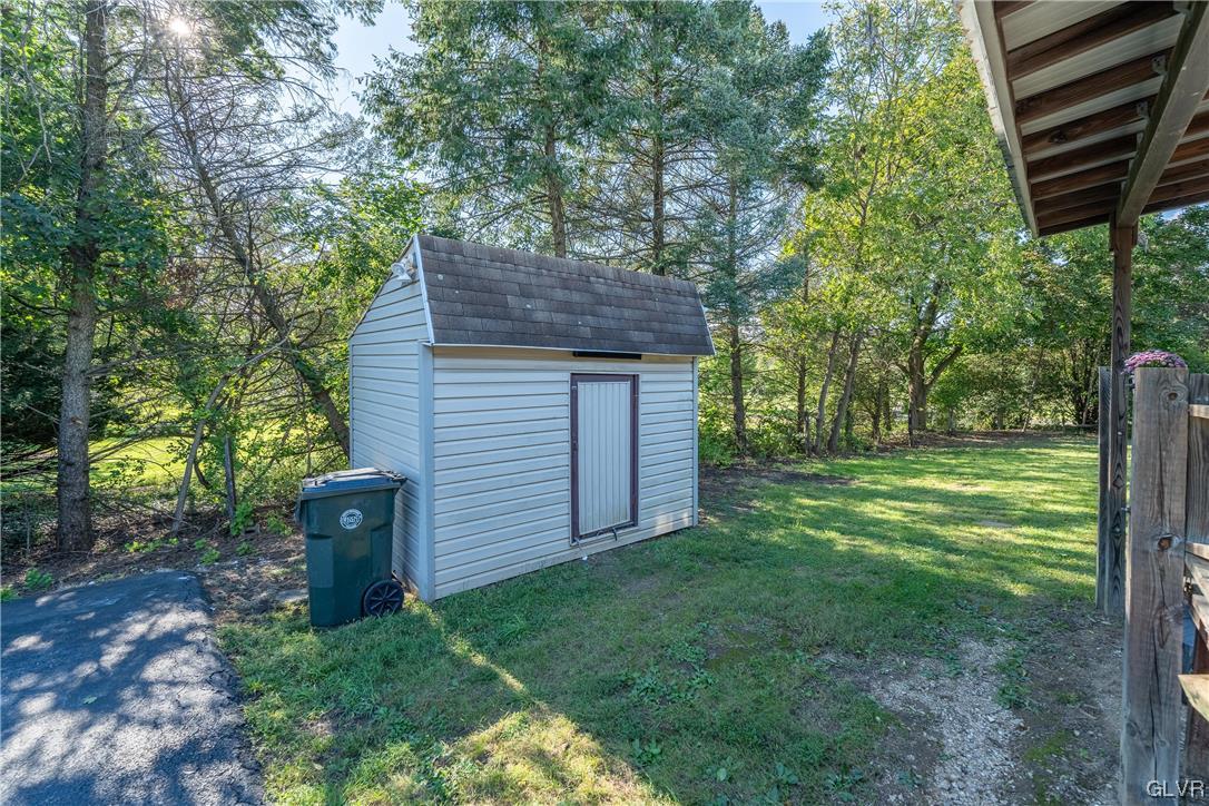 6991 Hilltop Road Allentown, PA 18106 - Photo 25 of 26 a view of a backyard with plants and large trees