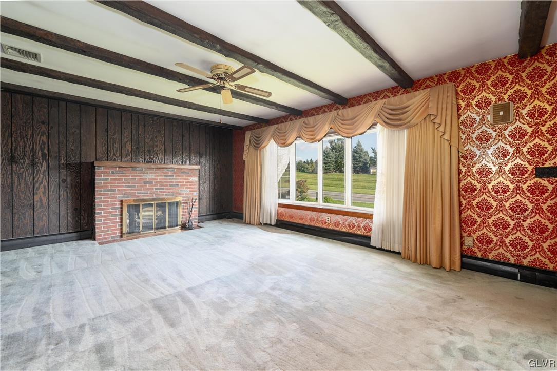 6991 Hilltop Road Allentown, PA 18106 - Photo 6 of 26 a view of an empty room with a fireplace and a window