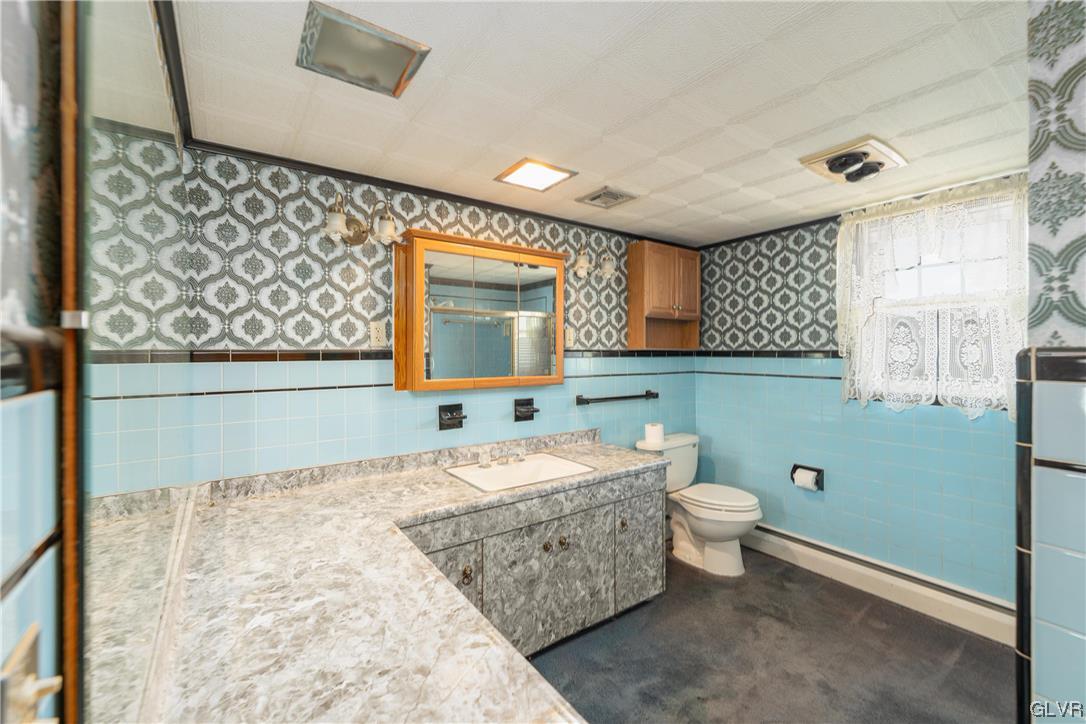 6991 Hilltop Road Allentown, PA 18106 - Photo 7 of 26 a bathroom with a sink toilet and mirror