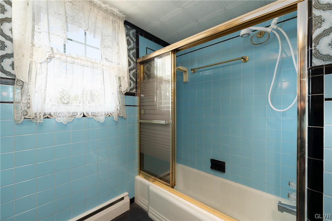 6991 Hilltop Road Allentown, PA 18106 - Photo 8 of 26 a bathroom with a shower and a bathtub