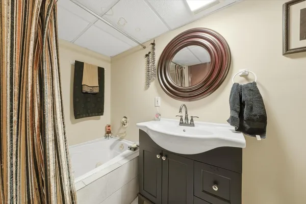 a bathroom with a sink a toilet and a mirror
