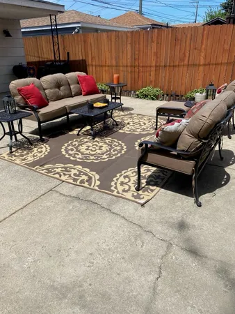 a view of a two chairs in the back yard of the house