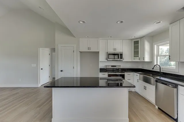 a kitchen with granite countertop a stove and a sink