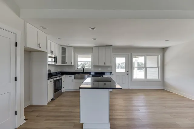 a kitchen with granite countertop a stove and a refrigerator