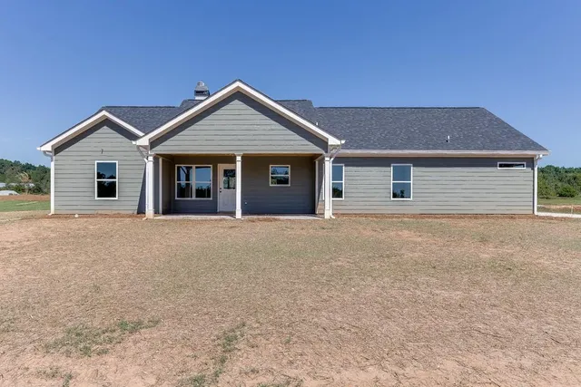 a view of a house with a yard and garage