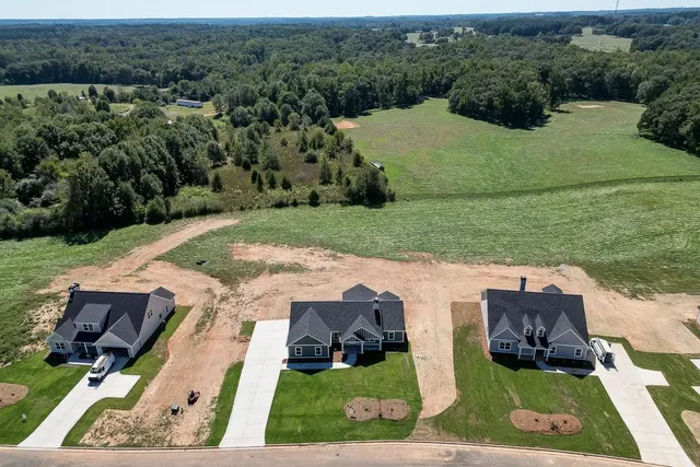 an aerial view of a house with yard swimming pool and outdoor seating