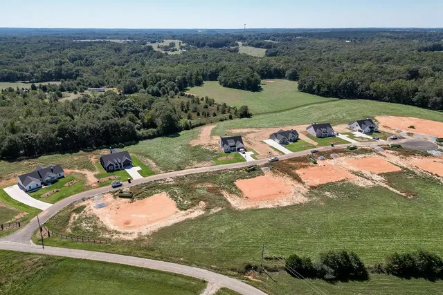 an aerial view of a house with yard