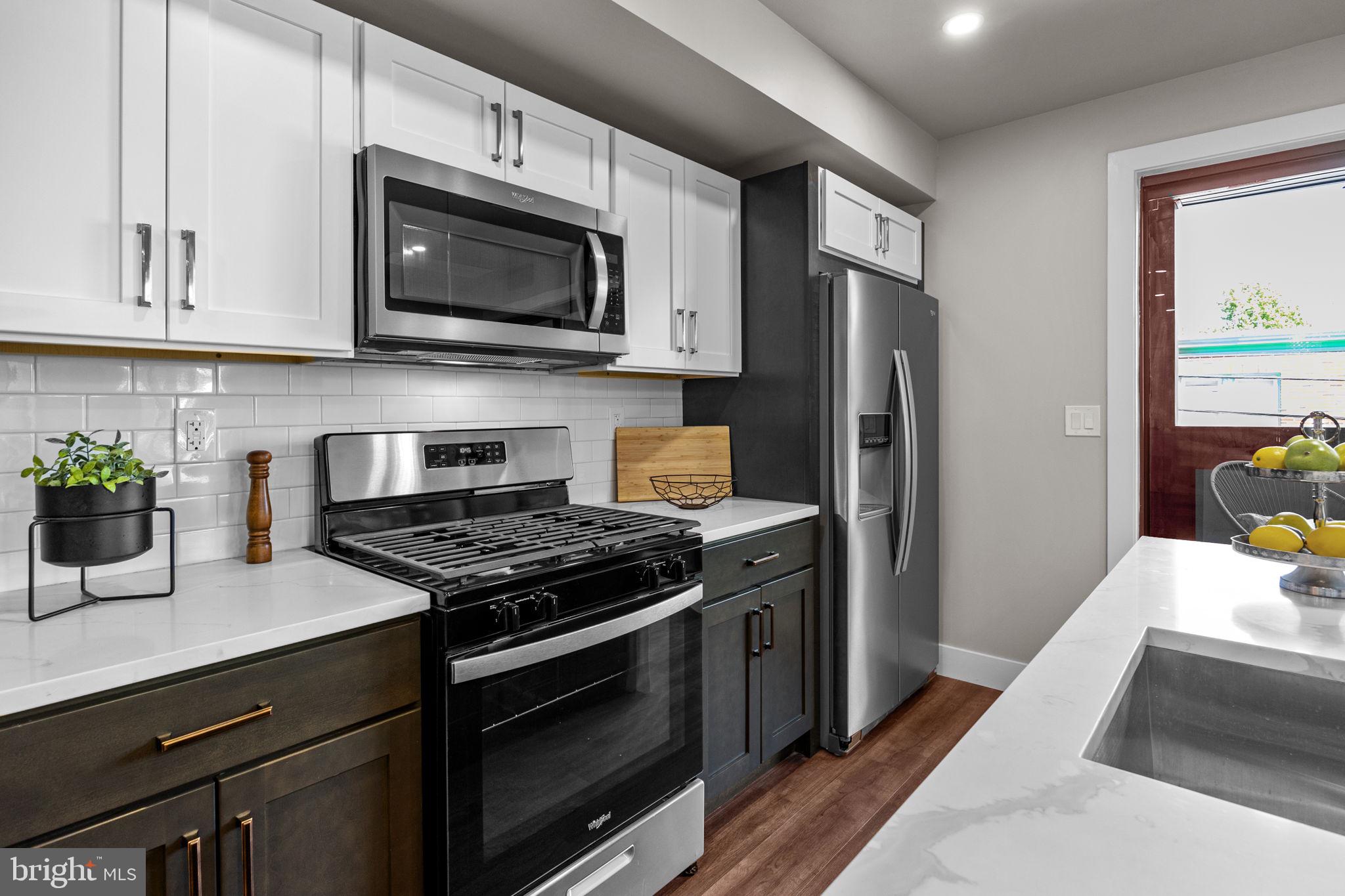 77 East Pastorius Street, Unit 1 Philadelphia, PA 19144 - Photo 11 of 43 a kitchen with stainless steel appliances a stove microwave and refrigerator