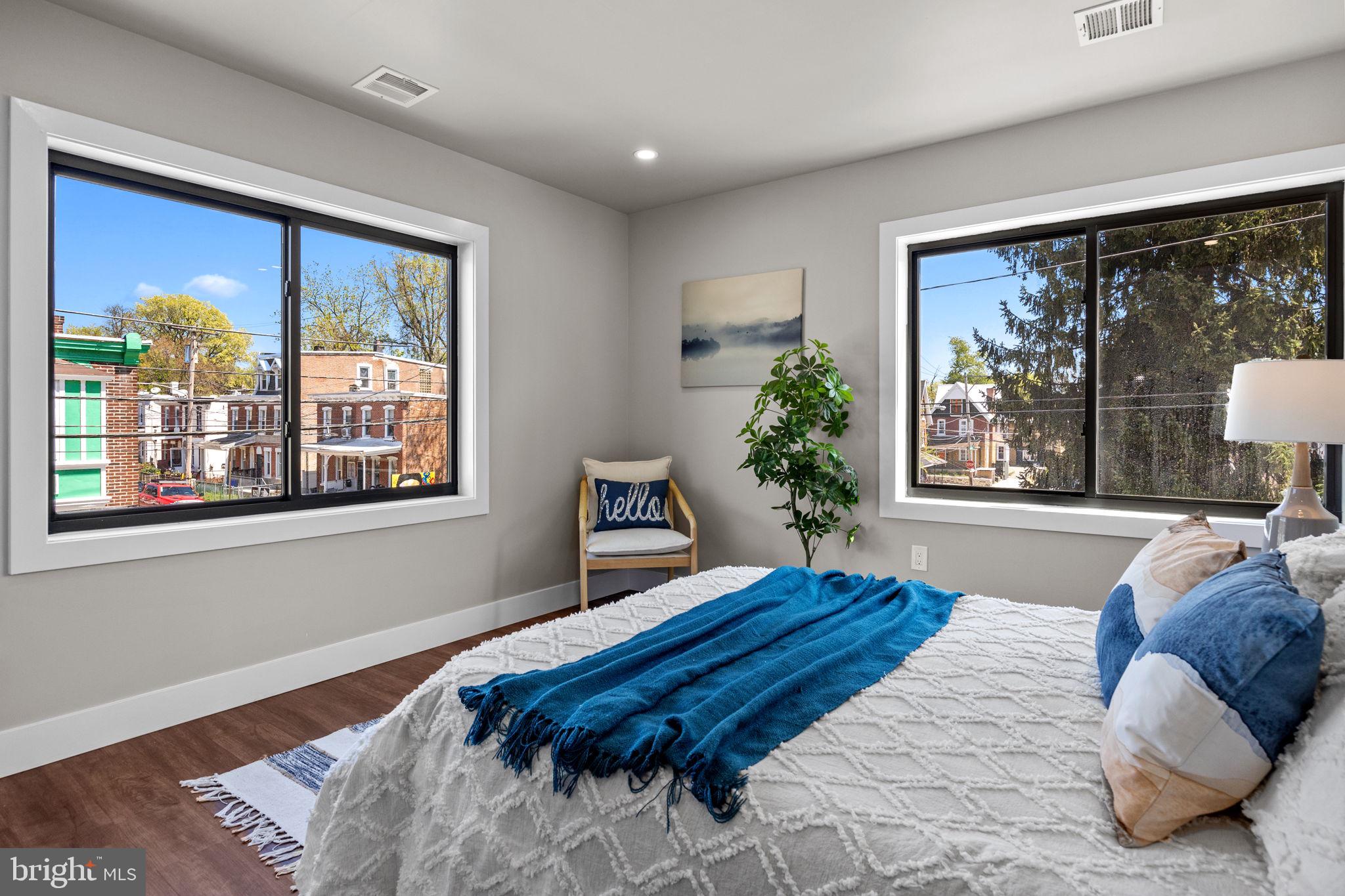 77 East Pastorius Street, Unit 1 Philadelphia, PA 19144 - Photo 15 of 43 a bedroom with a large bed and a large window