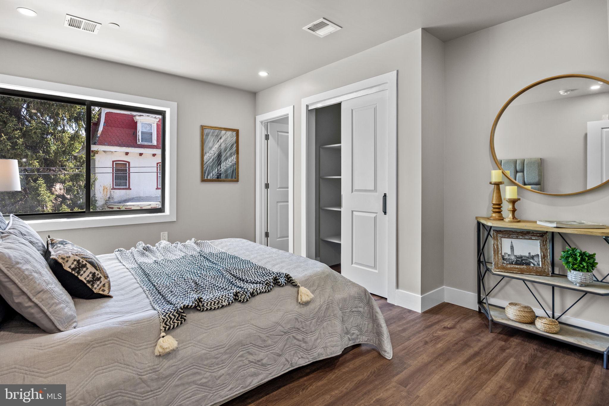 77 East Pastorius Street, Unit 1 Philadelphia, PA 19144 - Photo 17 of 43 a bedroom with a bed and wooden floor