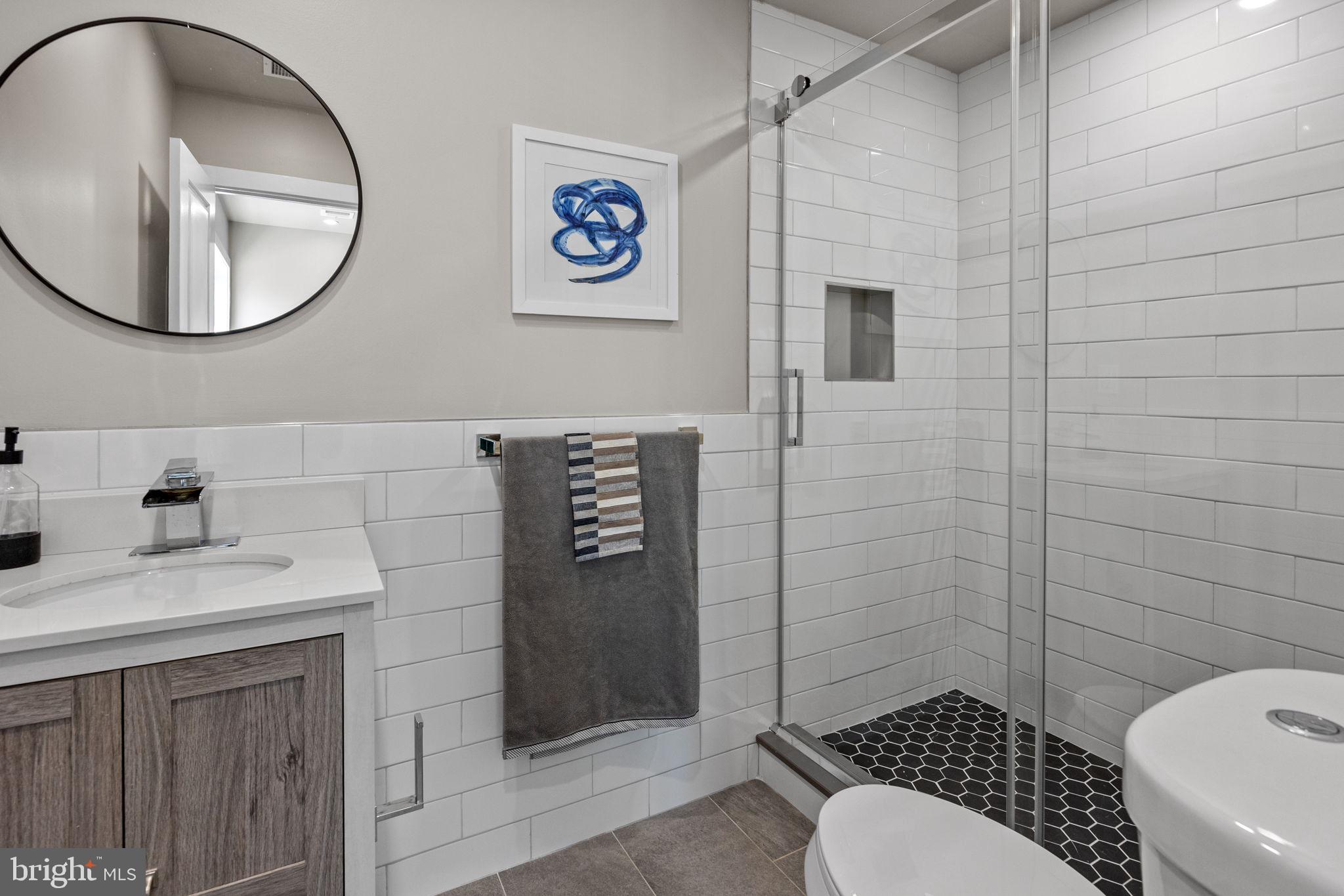 77 East Pastorius Street, Unit 1 Philadelphia, PA 19144 - Photo 19 of 43 a bathroom with a toilet sink vanity and mirror