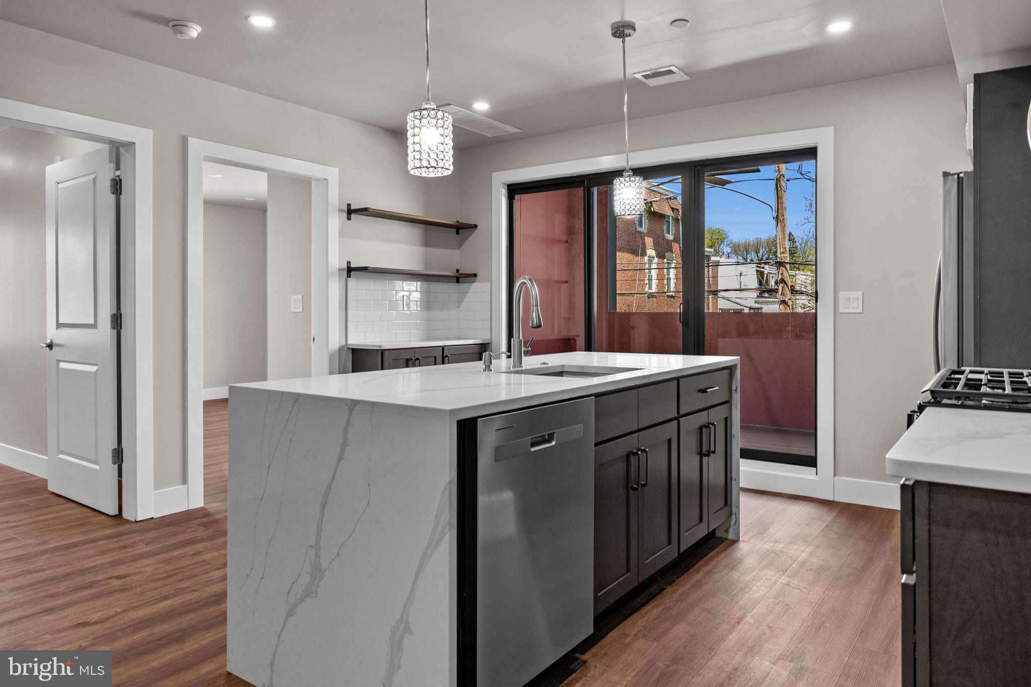 77 East Pastorius Street, Unit 1 Philadelphia, PA 19144 - Photo 31 of 43 a kitchen with stainless steel appliances granite countertop a sink a stove and a refrigerator