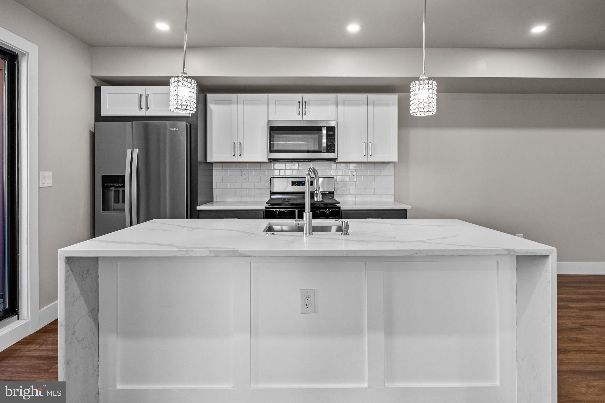 77 East Pastorius Street, Unit 1 Philadelphia, PA 19144 - Photo 32 of 43 a kitchen with stainless steel appliances a sink and microwave