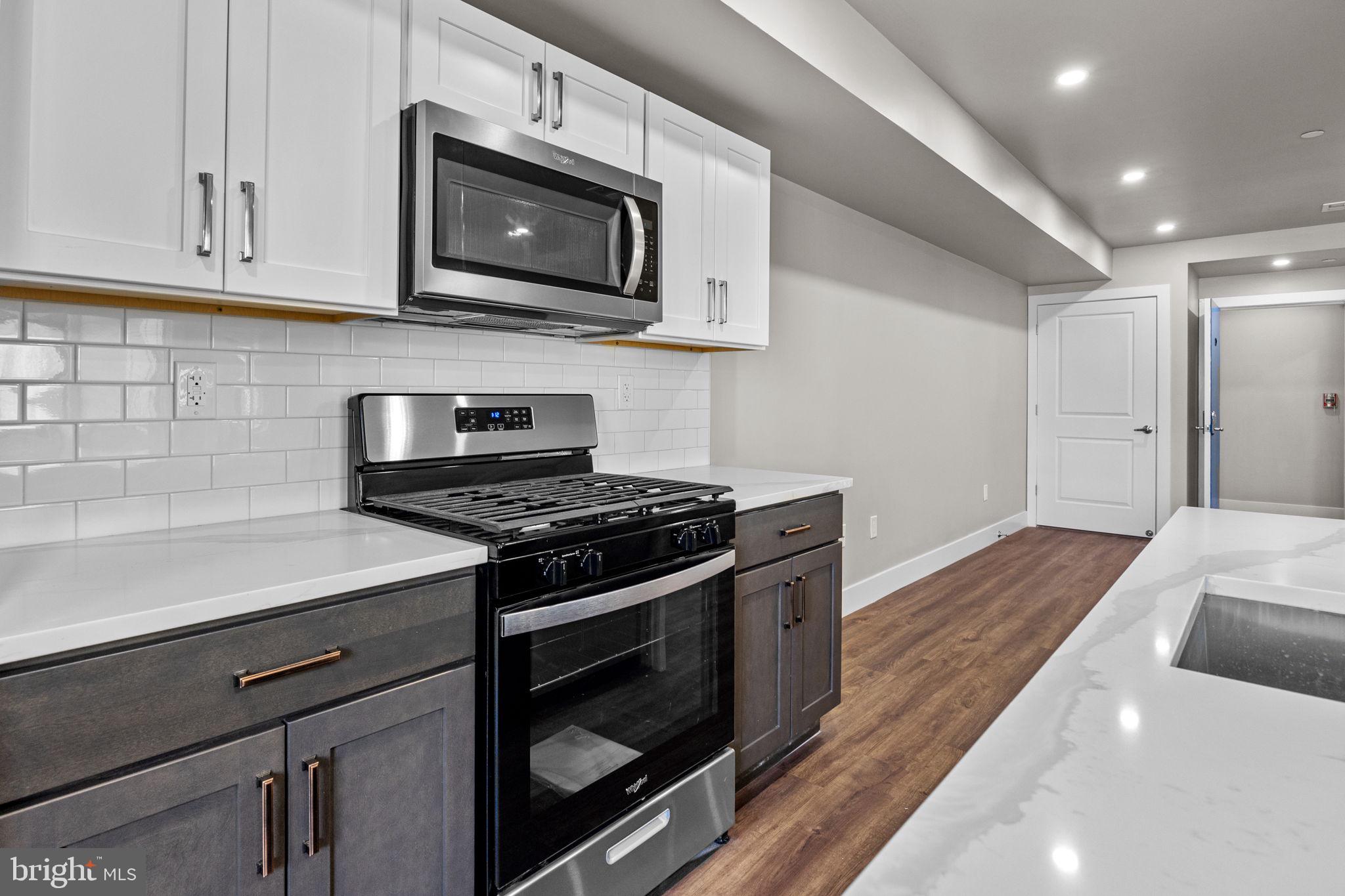 77 East Pastorius Street, Unit 1 Philadelphia, PA 19144 - Photo 33 of 43 a kitchen with stainless steel appliances a stove microwave and sink