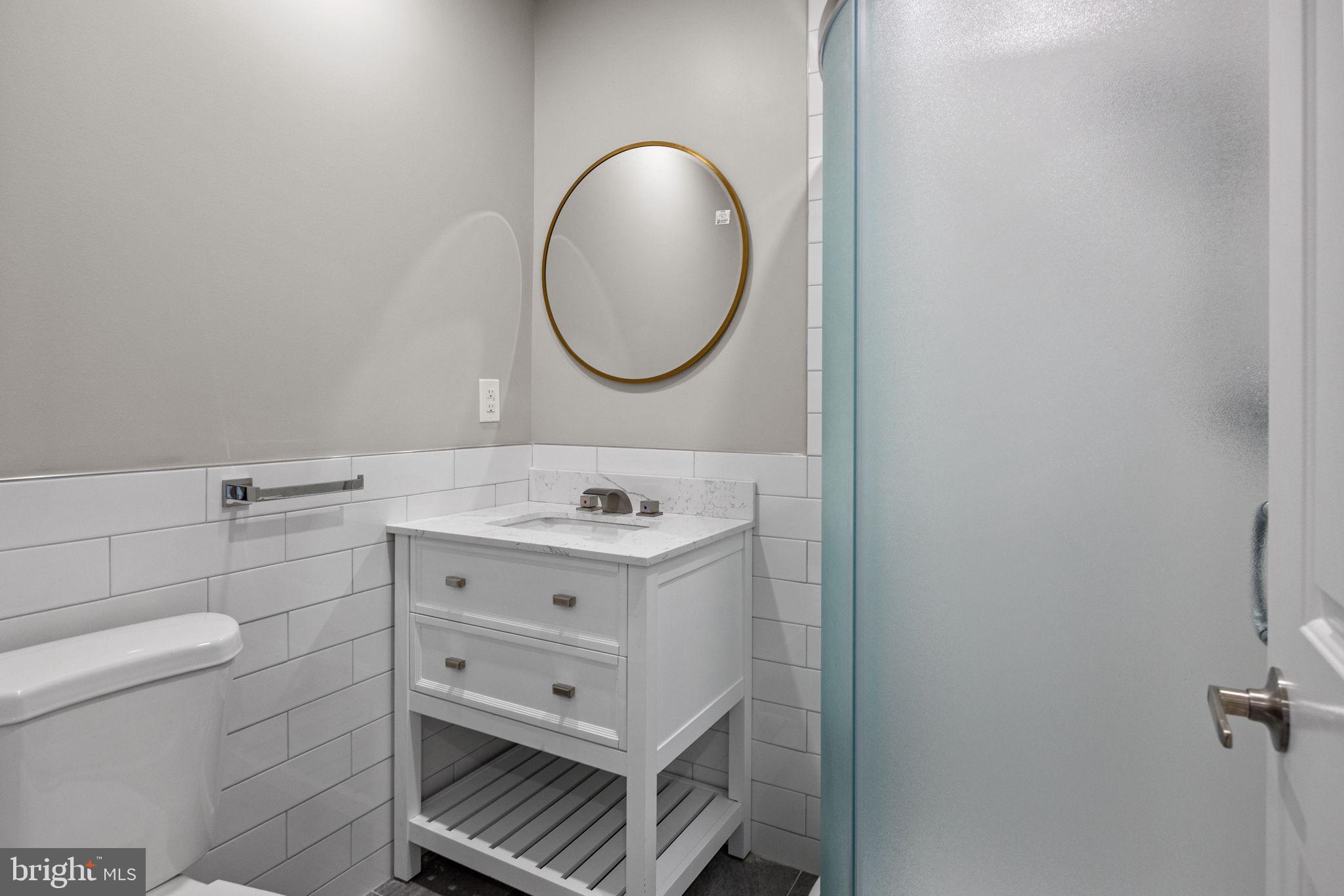 77 East Pastorius Street, Unit 1 Philadelphia, PA 19144 - Photo 35 of 43 a bathroom with a sink mirror vanity and toilet