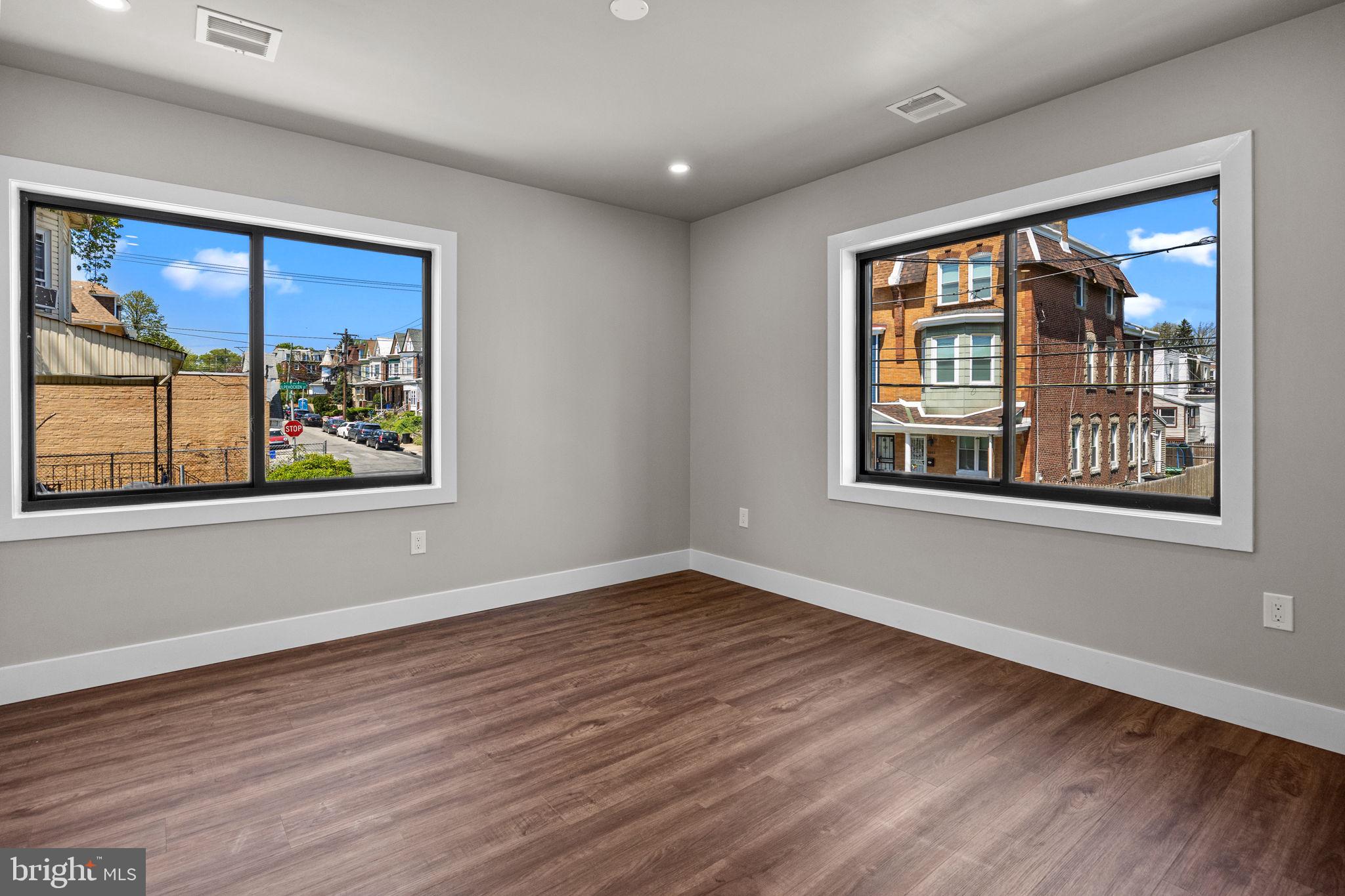 77 East Pastorius Street, Unit 1 Philadelphia, PA 19144 - Photo 36 of 43 a view of an empty room with a window and wooden floor