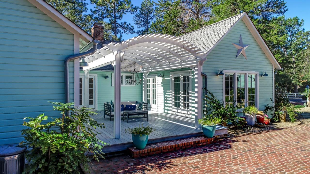 389 Old Mail Road Southern Pines, NC 28387 - Photo 25 of 54 Back deck with pergola overlooking the saltwater pool