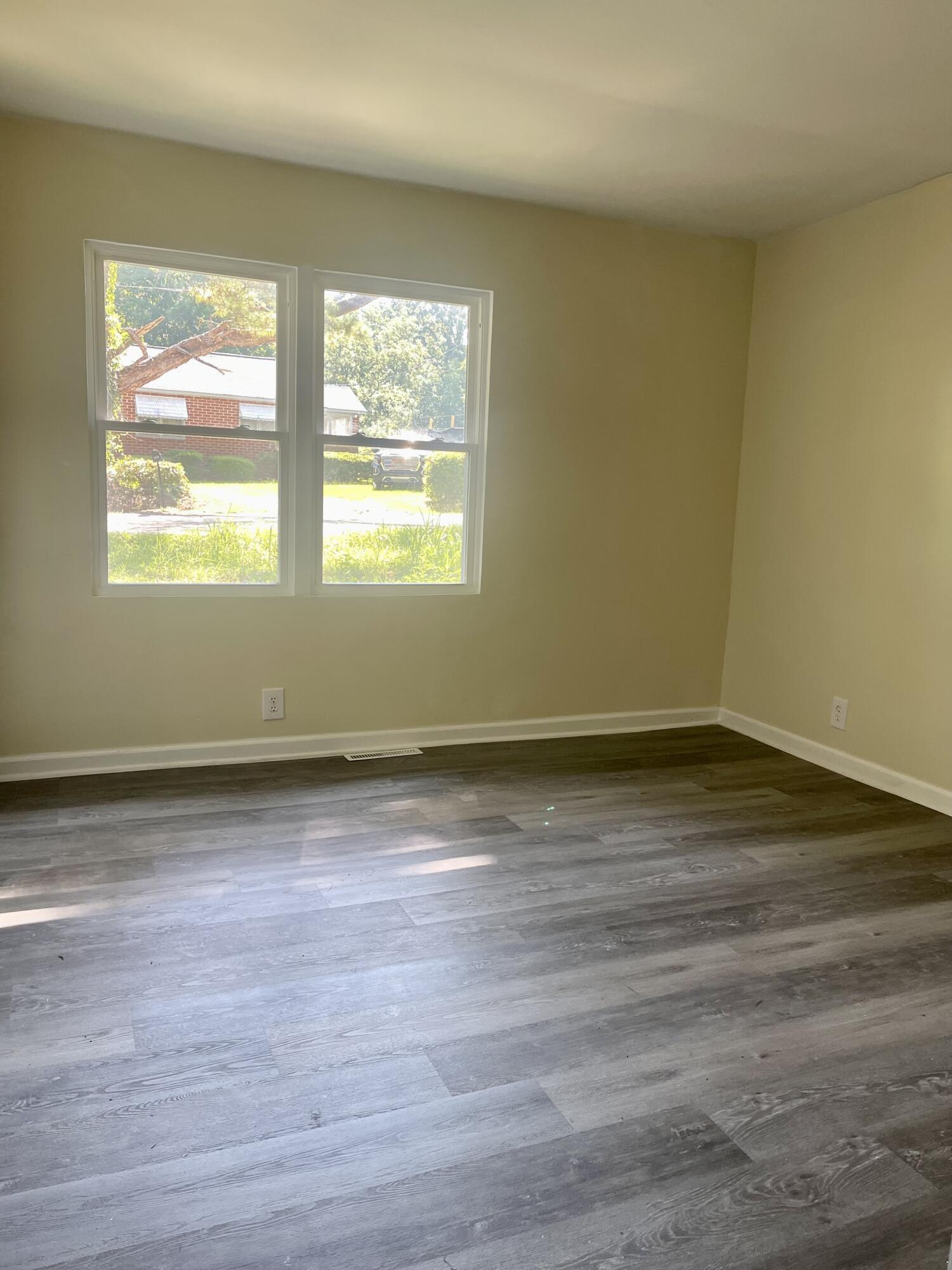 425 Rosa Hill Street Edgefield, SC 29824 - Photo 12 of 14 an empty room with wooden floor and windows