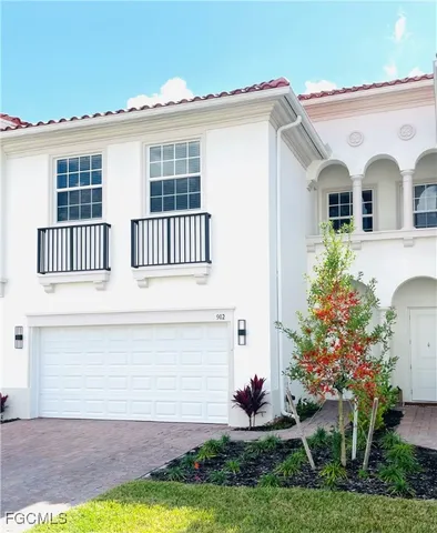 a view of a white house with yard and plants