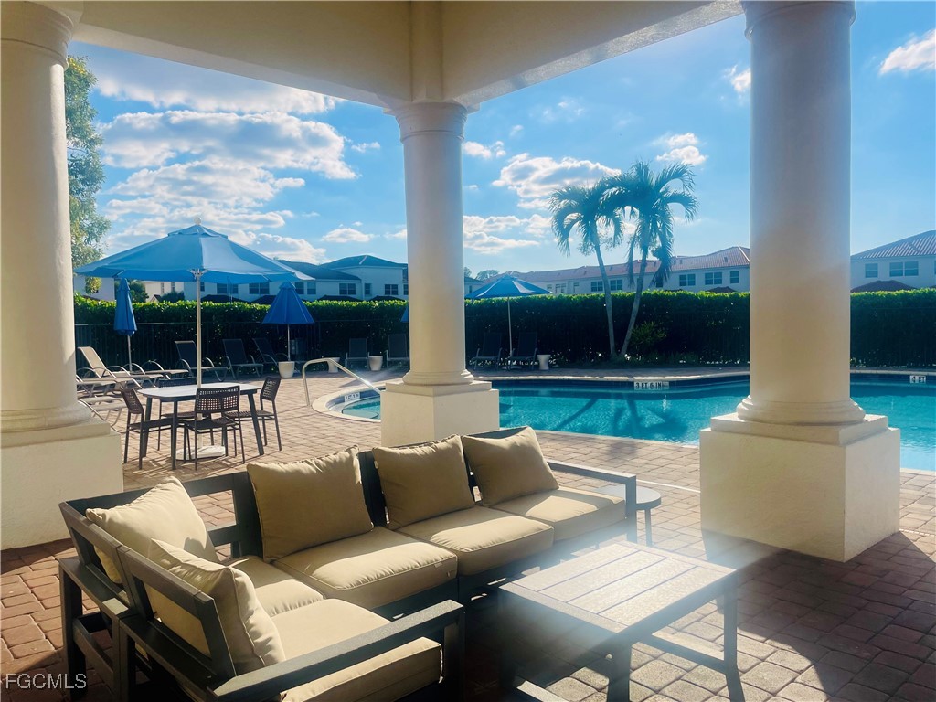 7024 Ambrosia Lane, Unit 902 Naples, FL 34119 - Photo 5 of 10 a outdoor living space with patio furniture