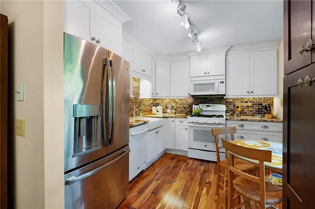 a kitchen with stainless steel appliances a refrigerator sink and microwave