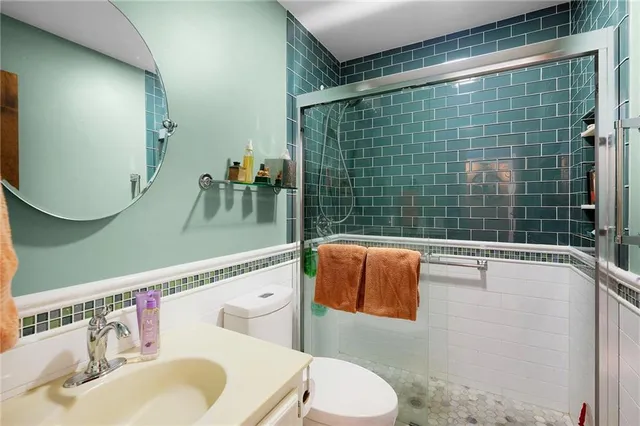 a bathroom with a sink toilet and shower