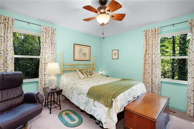 a bedroom with a bed a window and a chandelier