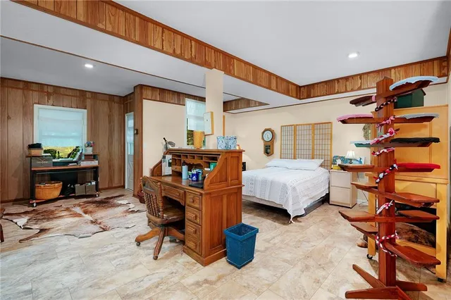 a bedroom with furniture and a wooden floor