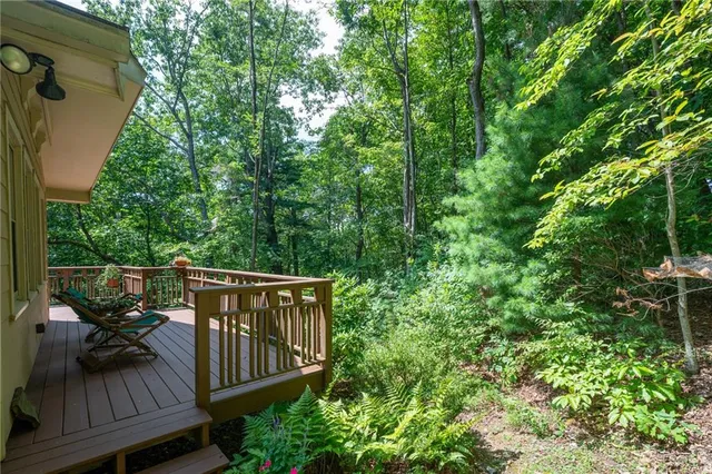 a view of balcony with wooden floor and outdoor seating