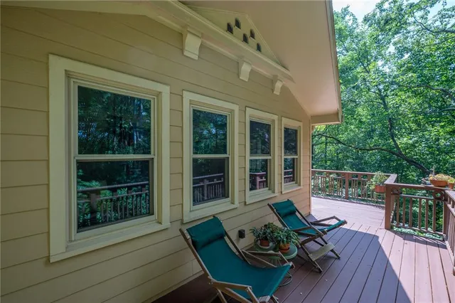 a view of a deck with couches table and chairs and wooden floor