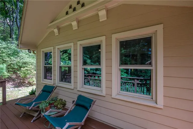 a view of a house with porch and garden