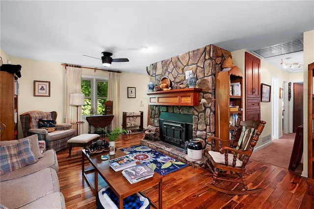a living room with patio fireplace furniture and a flat screen tv