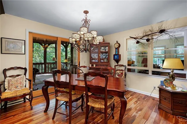 a view of a dining room with furniture and chandelier