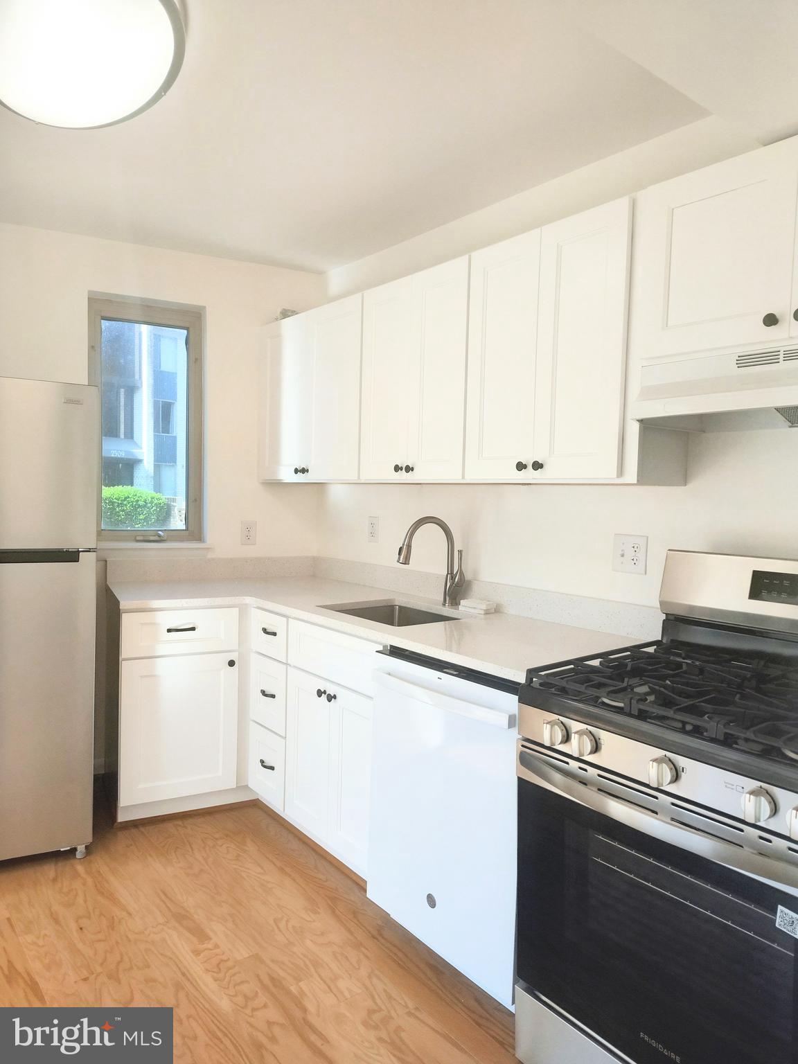 2515 Baltimore Road, Unit 25153 Rockville, MD 20853 - Photo 19 of 25 a kitchen with granite countertop white cabinets and appliances