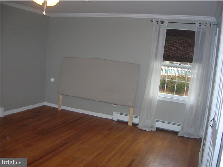 203 Grubb Road Pottstown, PA 19465 - Photo 14 of 25 an empty room with wooden floor and windows