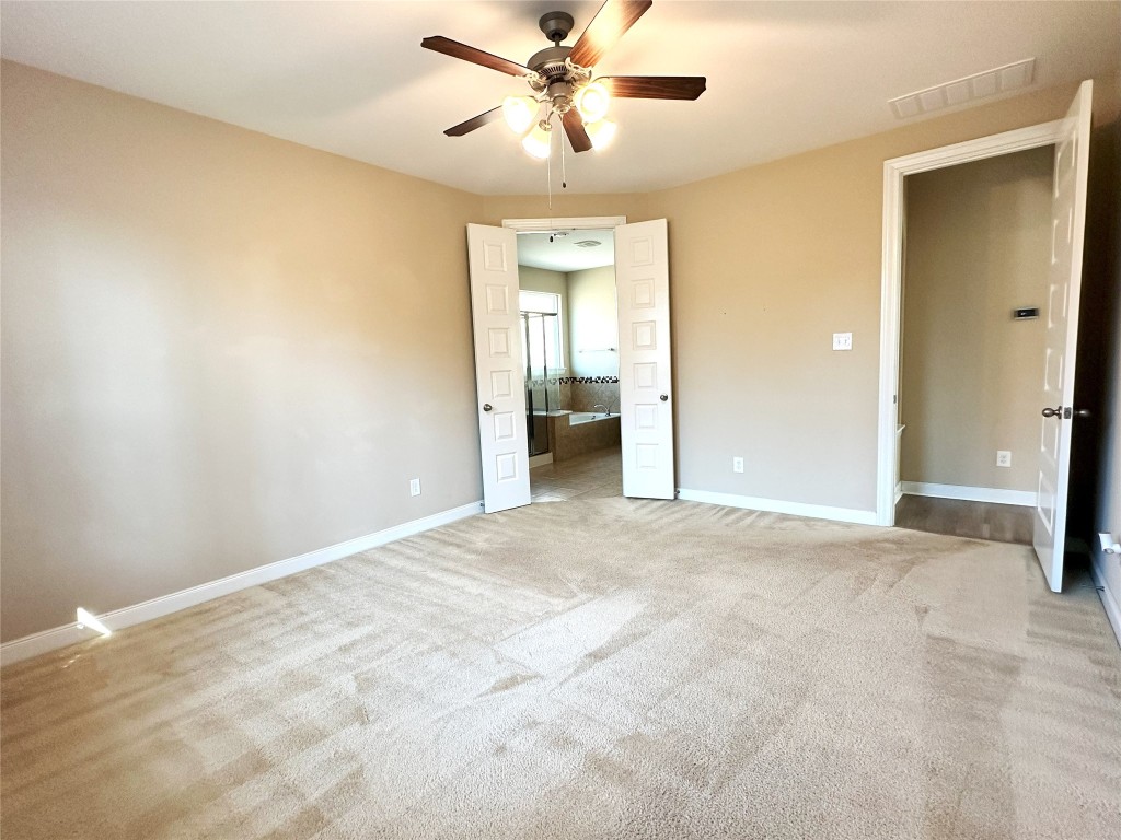 22523 Birch Ridge Meadow Drive Spring, TX 77389 - Photo 12 of 33 an empty room with chandelier fan and windows